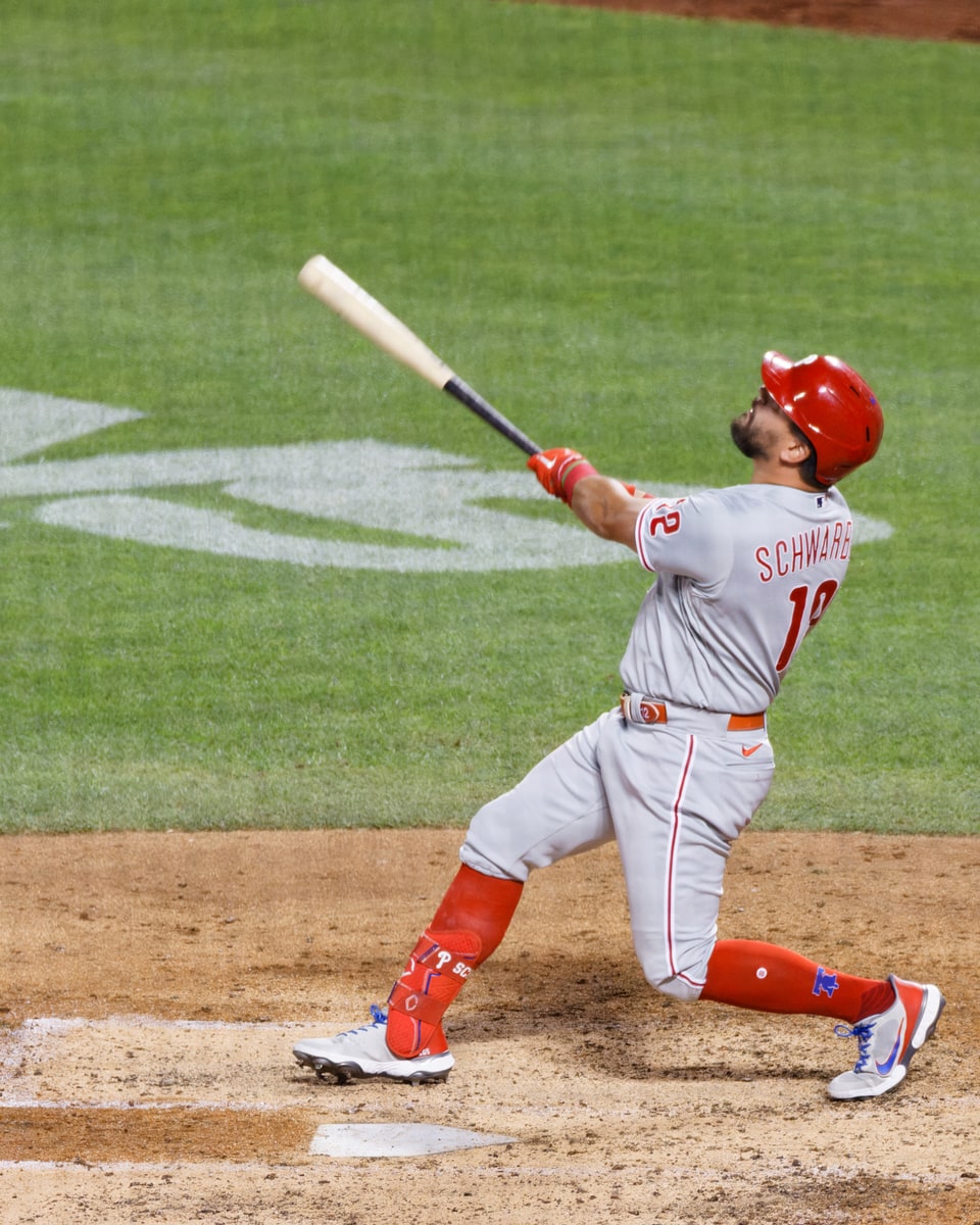 Kyle Schwarber watches a fly ball after his swing for the Philadelphia Phillies in 2022.