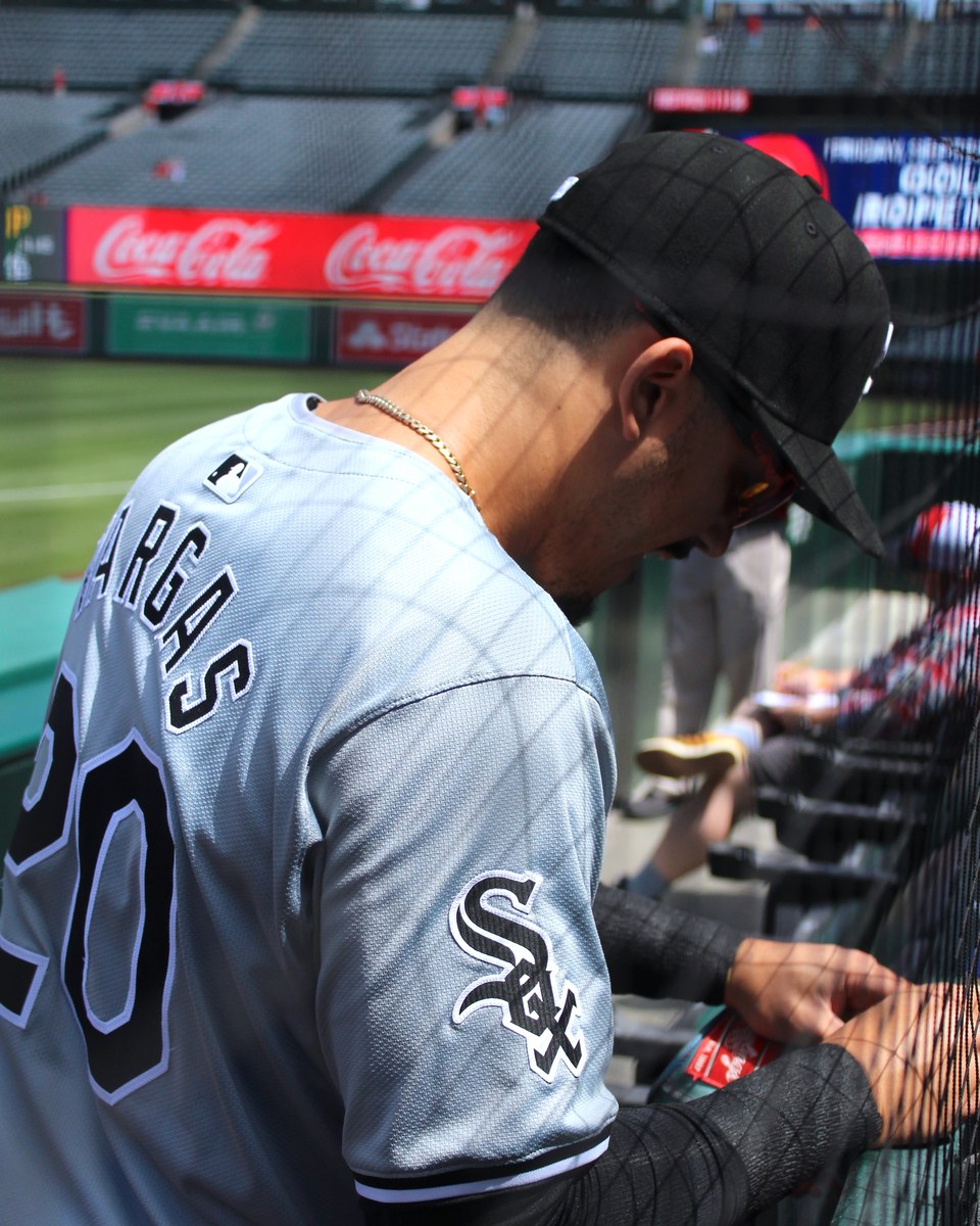 Miguel Vargas signs autographs for fans in his Chicago White Sox uniform before a September 2024 game.